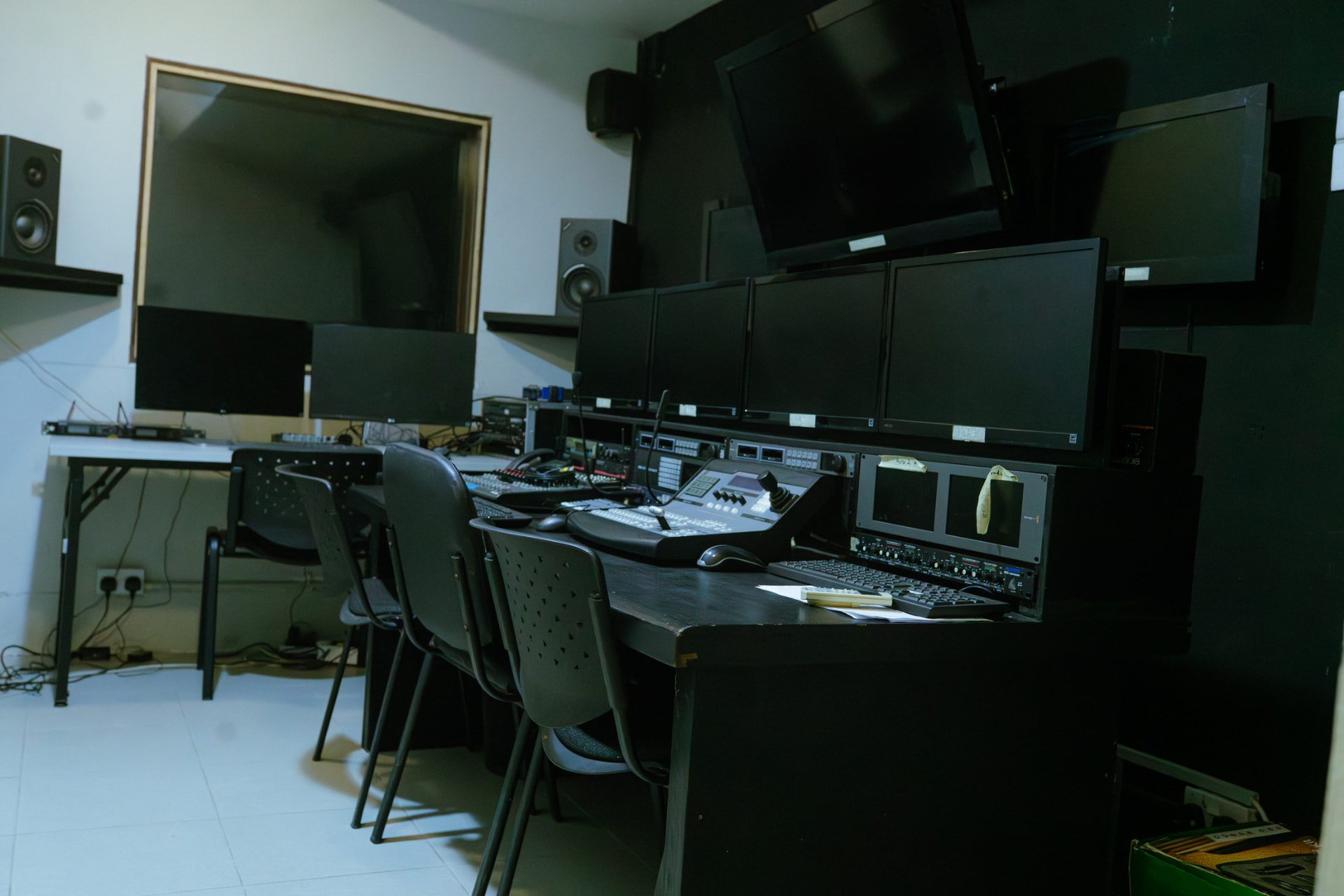 Studio control room with monitor wall, vision mixer and talkback to the shooting floor